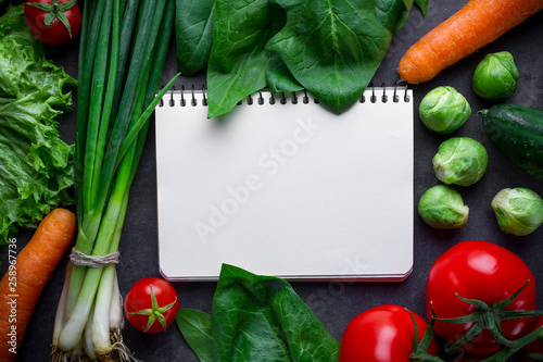 Blank recipe book and ingredients for cooking fresh healthy vegetables dishes. Clean food and balanced diet. Copy space. Diet plan  conrtol food