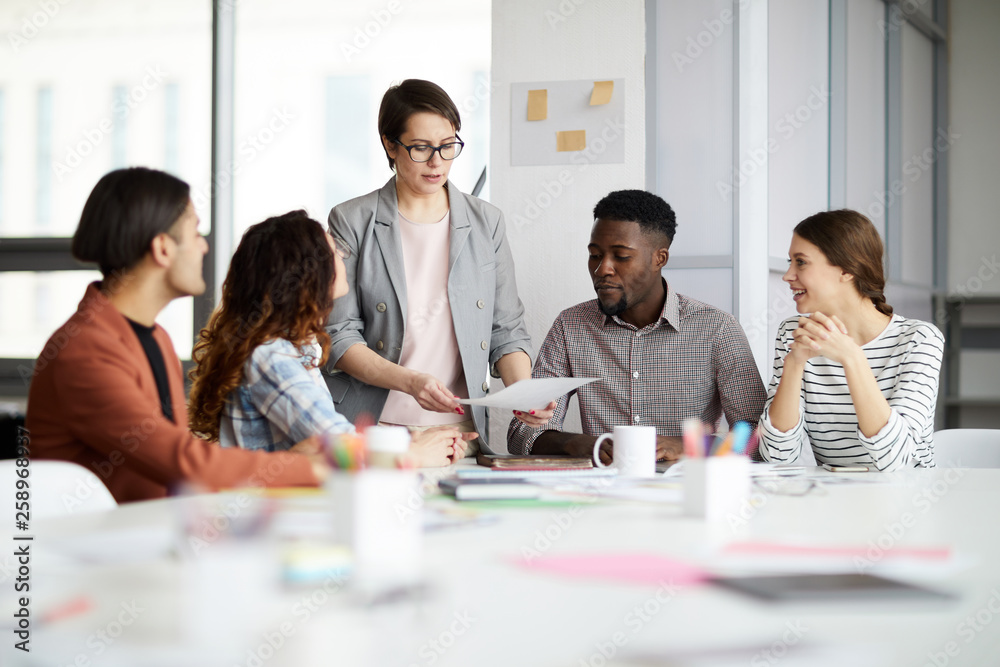 © Seventyfour - Portrait of successful female manager leading multi-ethnic team in meeting, copy space