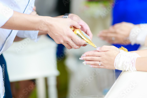 Hands pouring blessing water in wedding thailand