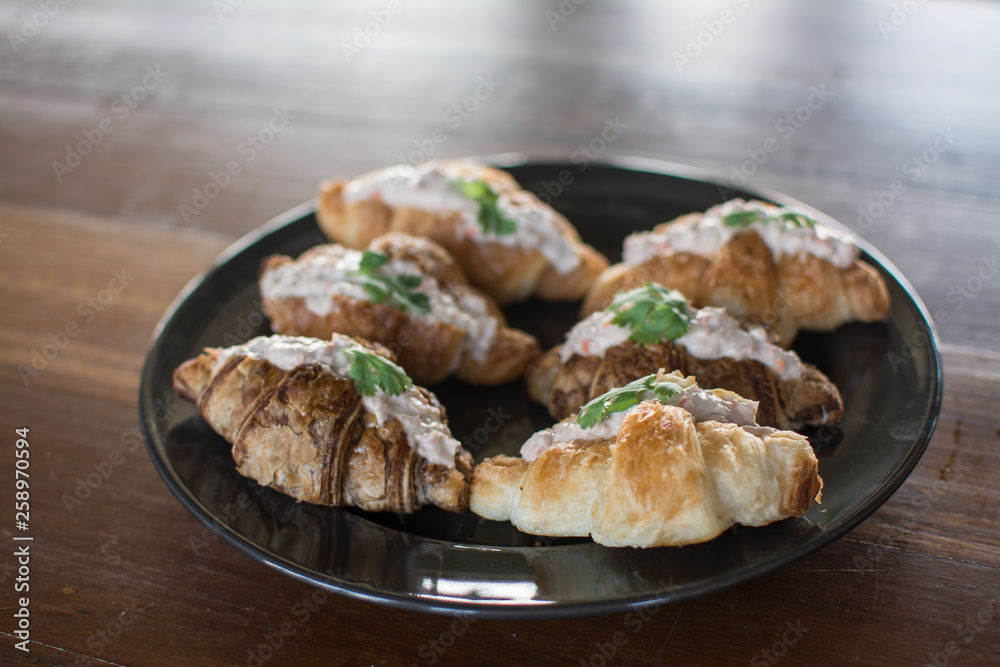 Croissant with Tuna Salad  Sandwich on wood table