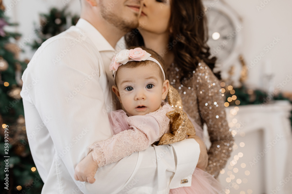Little girl is happy in the arms of her parents Little girl is happy in the arms of her parents