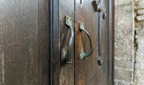 Antique brass handles on a wooden church door