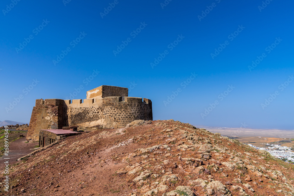 Spain, Lanzarote, Ancient ruins of castle called castello santa barbara on mountain guanapay