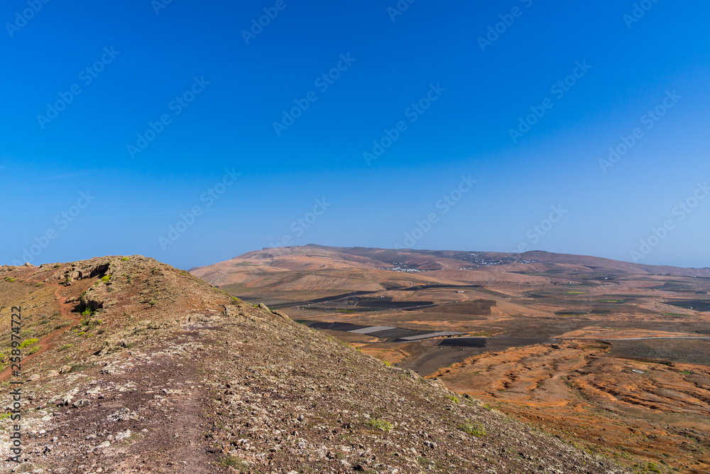 Spain, Lanzarote, Beautiful scenic view from mountain guanapay over endless volcanic landscape