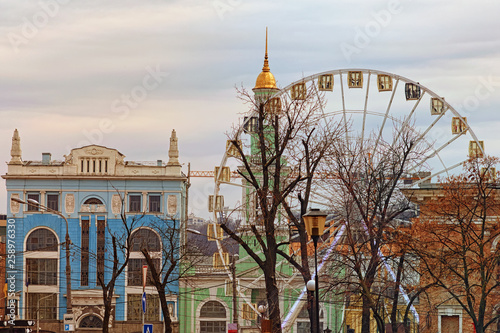 Beautiful landscape view of colorful ancient buildings on Kotraktova square (Cotract square). Ferris wheel in historical part of city. Podil, Kyiv, Ukraine