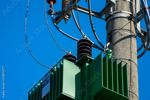 Detail of a transformer on electric pole with insulators