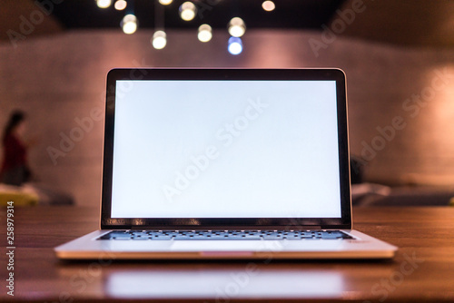 Conceptual workspace, Laptop computer with blank white screen on table, blurred background. use in Traditional Chinese Alphabet operating system.