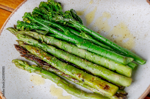 Grilled Homemade asparagus topped with extra virgin olive oil - Image