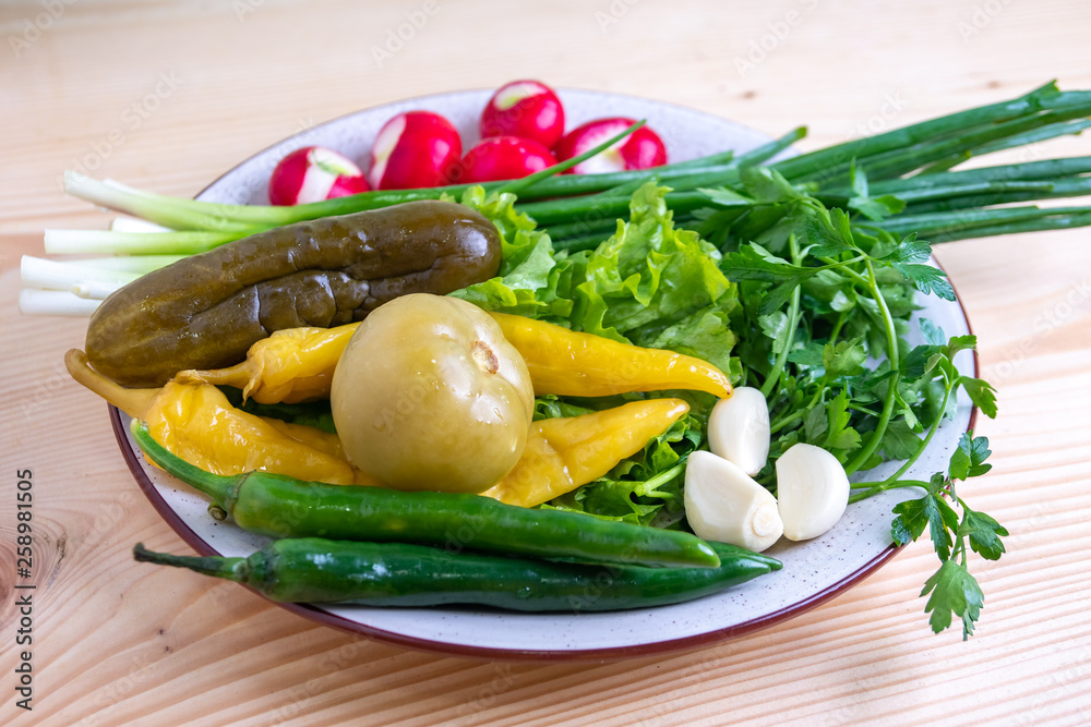 radish, parsley, onion, pickled cucumber and other vegetables on a plate radish, parsley, onion, pickled cucumber and other vegetables on a plate