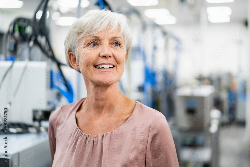 Portrait of smiling senior woman in a factory Portrait of smiling senior woman in a factory