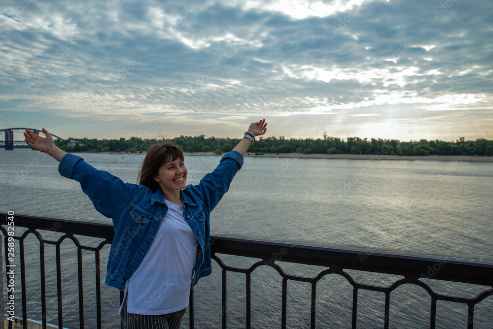 young smiling pretty woman at riverside on sunrise young smiling pretty woman at riverside on sunrise