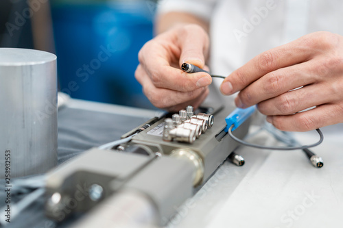 Close-up of man working on workpiece in a factory photo