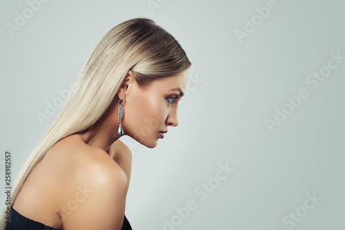 Woman with Healthy Blonde Hairstyle, Makeup and Black Pearls Earrings