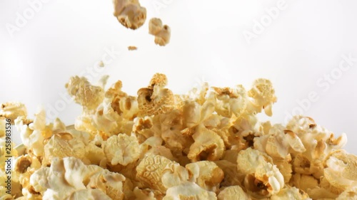 Delicious popcorn falling, landing and gathering in slow motion