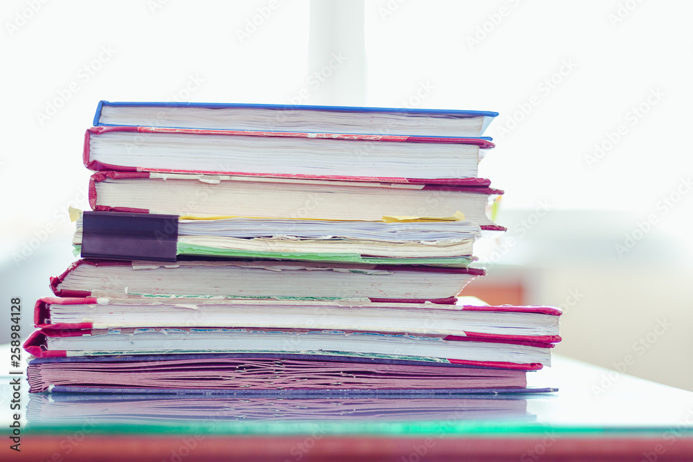 Stack of documents placed on a business desk in a business office. Stack of documents placed on a business desk in a business office.