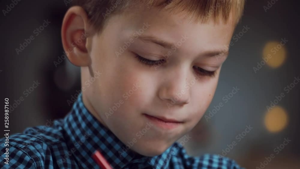 Focused little boy sitting at table and drawing with colored pencils. Art class, talent, educational concept. Creativeness, having fun, relaxation, art therapy. Child�s portrait Focused little boy sitting at table and drawing with colored pencils. Art class, talent, educational concept. Creativeness, having fun, relaxation, art therapy. Child�s portrait