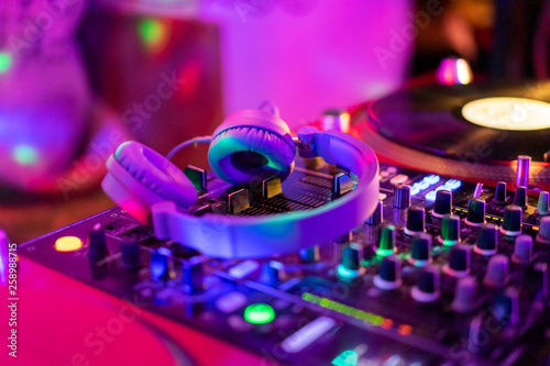 Headphones on illuminated mixing board