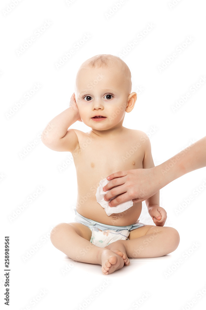 Hygiene - young momy wiping the baby skin with wet wipes isolated on a white background Hygiene - young momy wiping the baby skin with wet wipes isolated on a white background