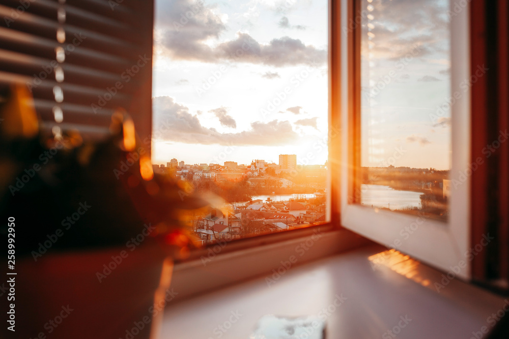 Fototapeta premium Bright evening sun in the open window