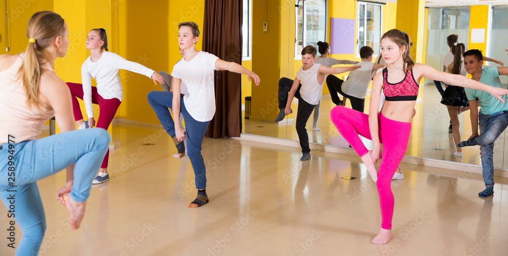 Children participating in dance class with teacher