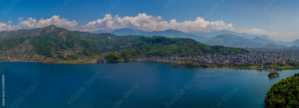 Naklejka premium A panoramic view of Pokhara in Nepal with mountain range behind the clouds