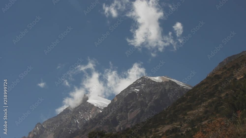 Wisps of clouds moving off mountain top peaks in Nepal Wisps of clouds moving off mountain top peaks in Nepal