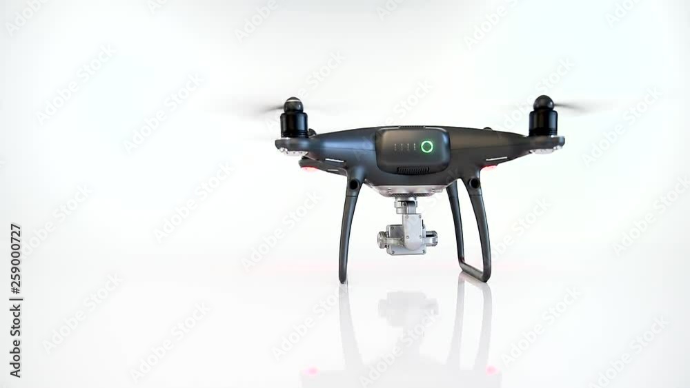 Black drone with camera landing on a white background. Quadcopter for flying and shooting 4K UHD video and photos. Black drone with camera landing on a white background. Quadcopter for flying and shooting 4K UHD video and photos.