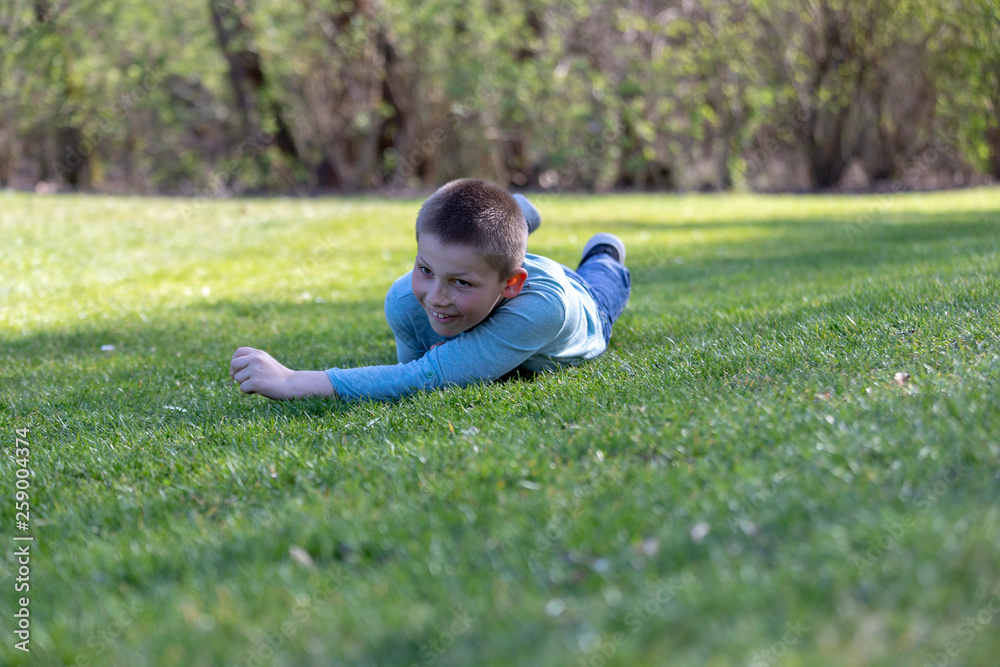 7 years old child lying on the grass in the Park 7 years old child lying on the grass in the Park
