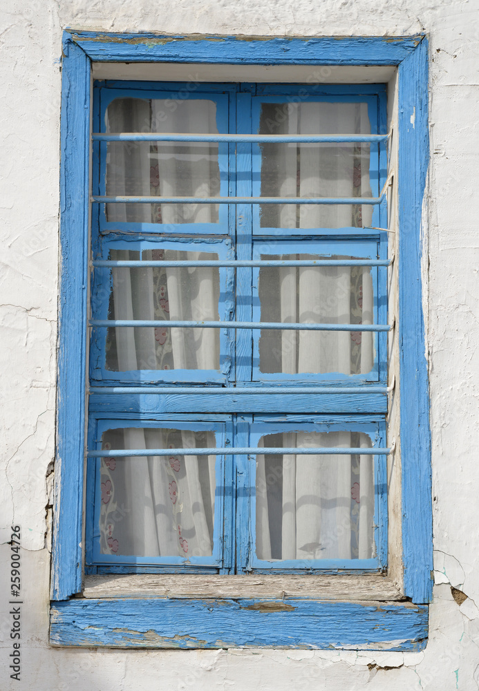 old blue window on a wall