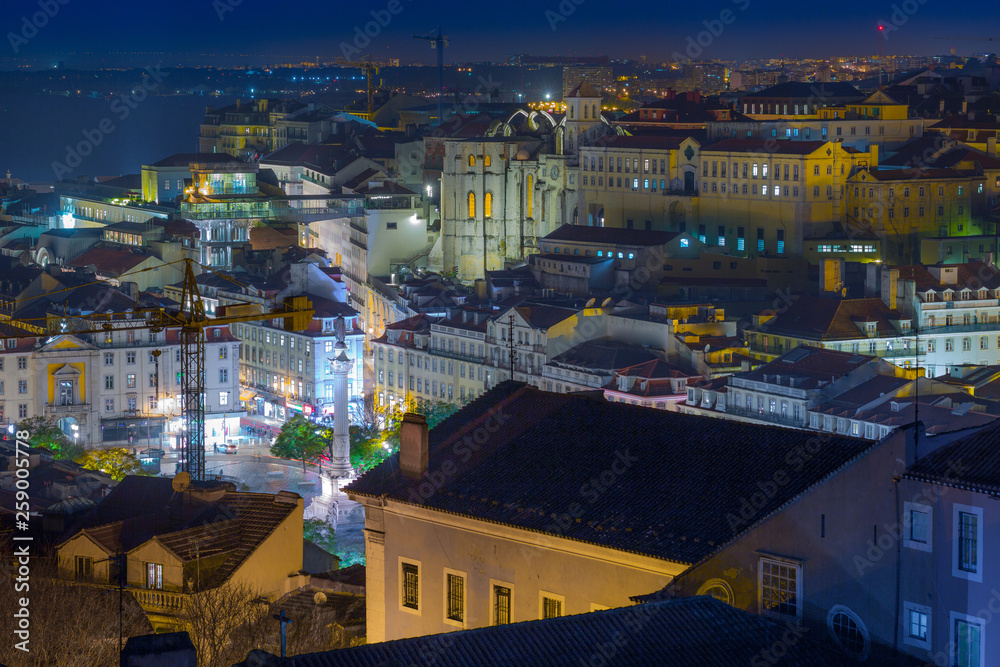 Fototapeta premium A beautiful night long exposure aerial cityscape. View of historic central quarters, Rossio Square, Convento do Carmo, elevador de Santa Justa in evening illumination, Lisbon, Portugal.