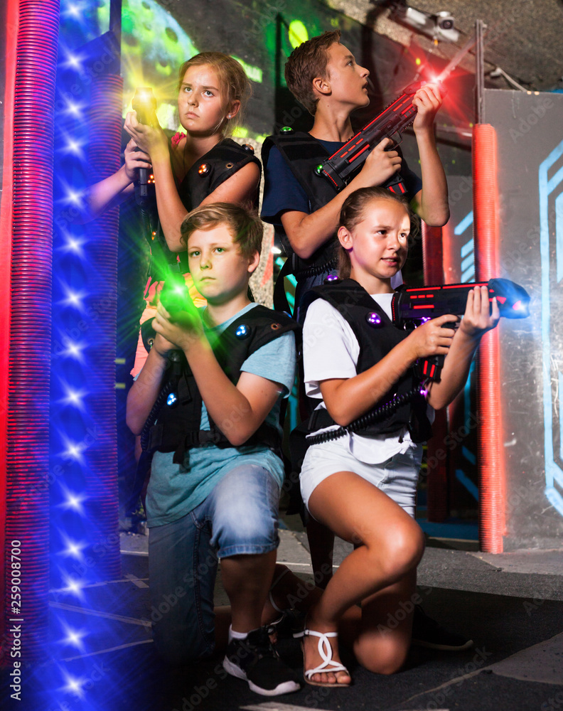 Fototapeta premium Happy teenagers with laser guns
