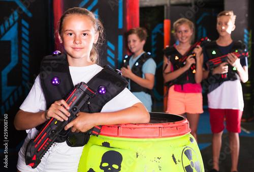 Girl with laser gun on lasertag arena