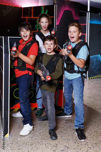 teen kids with laser guns during lasertag game