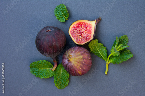 Fresh figs with mint and blueberries. Beautifulf berry, fruit background, frame for design with copy space. photo