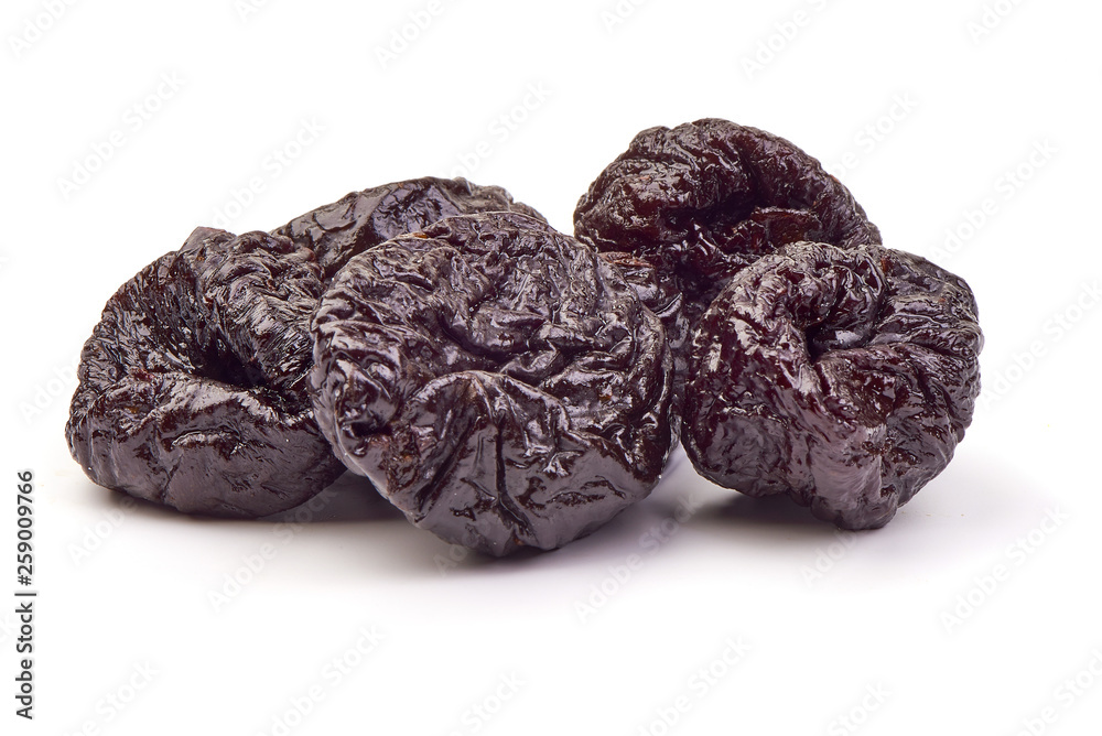 Dried plums fruits, tasty prunes, close-up, isolated on white background Dried plums fruits, tasty prunes, close-up, isolated on white background