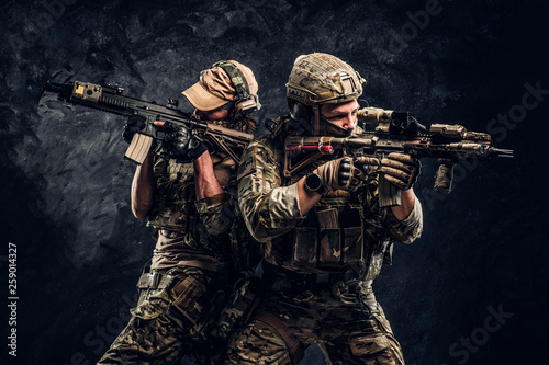 Obraz na plátně Private security service contractors, the elite special unit, full protective soldiers aiming at the targets