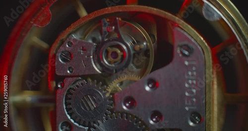 Old clock mechanical part working changing white and red lightning static macro view ProRes 4444