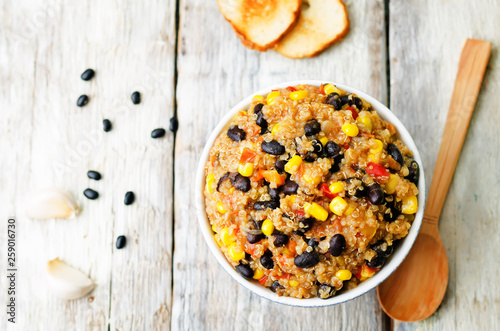 black beans, quinoa and corn chili on a wood background