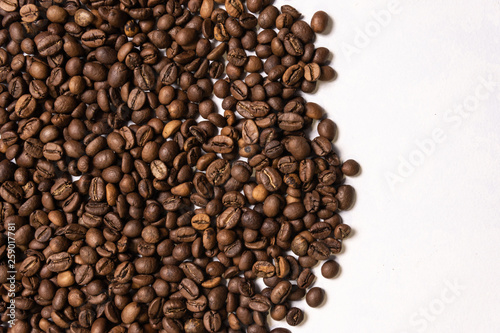 Roasted coffee beans in bulk on a light blue background. dark cofee roasted grain flavor aroma cafe, natural coffe shop background, top view from above, copy space