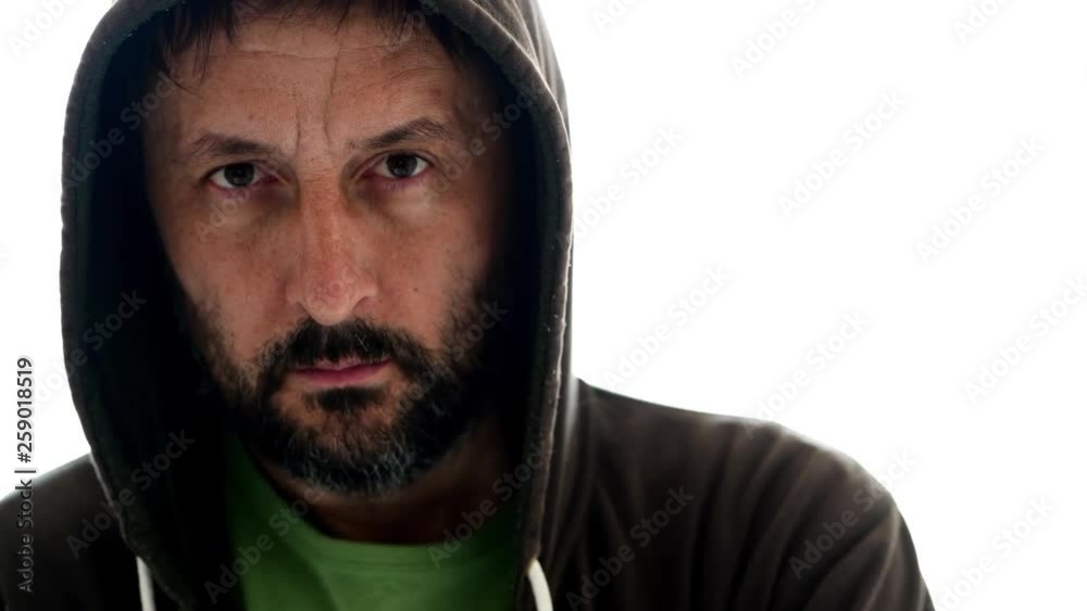 Portrait of thoughtful adult bearded male wearing hoodie and looking at camera, isolated on white background Portrait of thoughtful adult bearded male wearing hoodie and looking at camera, isolated on white background