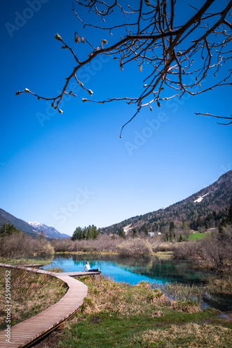 Lake Zelenci with observation trail footbridge in nature reserve Slovenia photo