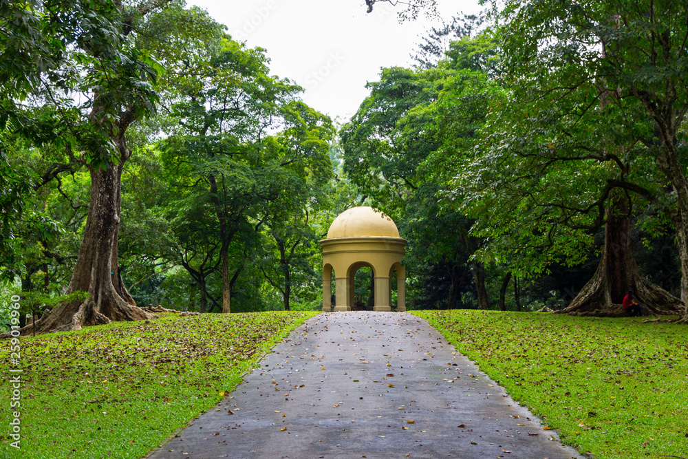 View of a park with a golden arbor in the background