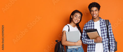 Education concept. Students holding exercise books, empty space photo