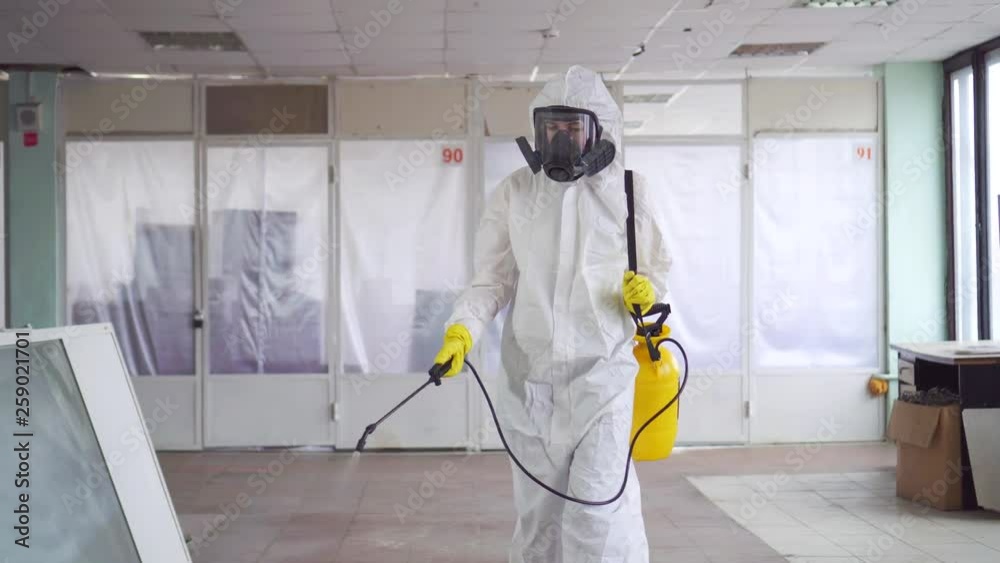 Exterminator in overalls and a protective mask with a sprayer Exterminator in overalls and a protective mask with a sprayer