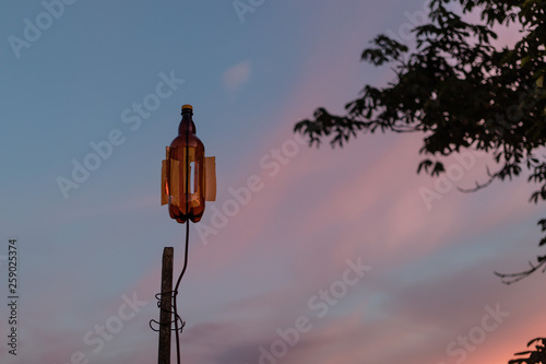 plastic bottle recycling - vane made from plastic beverage bottle against the sunset sky