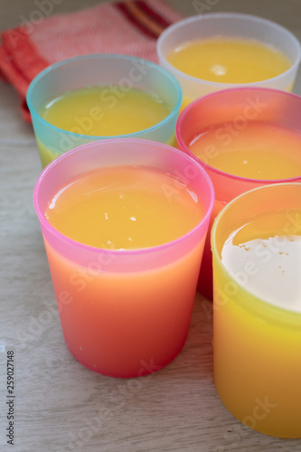 Orange Juice in colorful glasses.