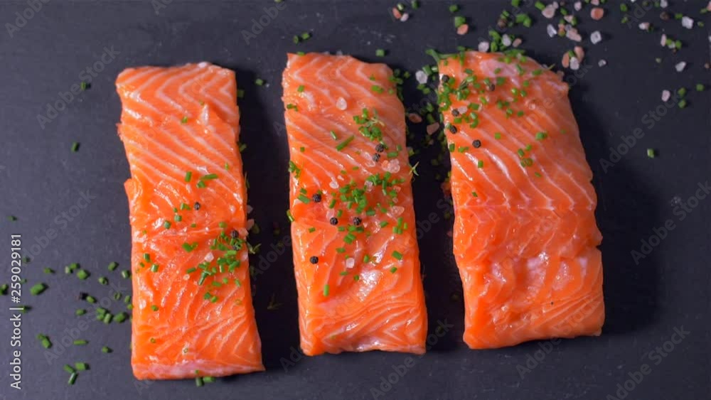 Sprinkle salmon fillet with spices. Slow motion