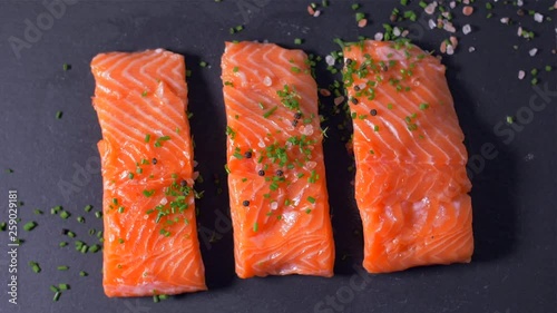 Sprinkle salmon fillet with spices. Slow motion