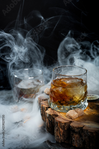 Alcohol cocktail with whiskey. Old Fashioned recipe ingredients on wooden board background.