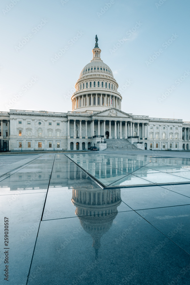 The United States Capitol reflecting in glass, in Washington, DC